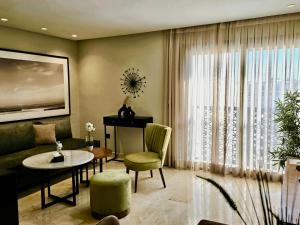 a living room with a couch and a table at AS Premium By Soho Hotels Maarif in Casablanca
