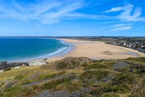 an aerial view of a beach and the ocean at Le BOTELLA in Teurthéville-Hague +16 photos