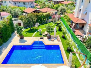 an aerial view of a swimming pool in a yard at Centrally Located Very Large Villa W Pool Jakuz and Car Park in Fethiye