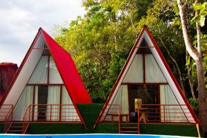 two triangular houses with red and white at Cabaña del Lago Sauce in Sauce +30 photos