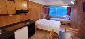 a small bedroom with a bed and a window at Res. Sole Alto appartamenti Solandra in Mezzana