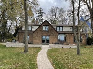a brick house with a walkway in front of it at The Pelton House in New Buffalo