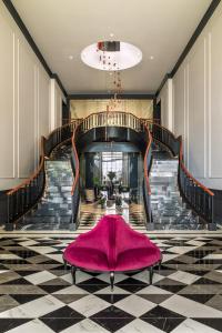 a large staircase with a pink rug on the floor at Maison Albar - Amoure in Braga