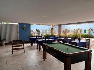 a pool table in a restaurant with tables and chairs at RESTAURANTE POUSADA E ESCUNA RIO SOl in São João da Barra