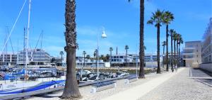 a boat docked at a marina with palm trees at Lagos Factory Yellow by Marina with AC in Lagos