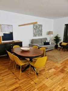 a living room with a table and chairs and a couch at Lagos Factory Yellow by Marina with AC in Lagos