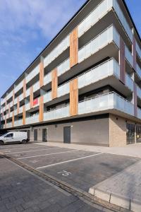 a parking lot in front of a building at SuperApart Modern Stay Ursynów Pileckiego - Parking w cenie in Warsaw