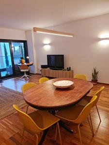 a living room with a wooden table and chairs at Lagos Factory Yellow by Marina with AC in Lagos