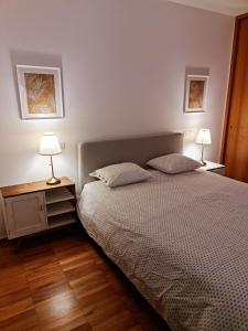 a bedroom with a bed with two lamps on it at Lagos Factory Yellow by Marina with AC in Lagos +30 photos