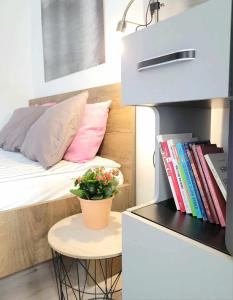 a small room with a bed and a table with a plant at STARE MiASTO II in Olsztyn