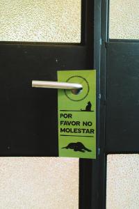 a sign on a door with a sign on it at Hotel San Fernando in Mexico City