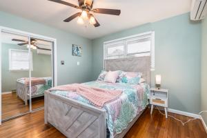 a bedroom with a bed and a ceiling fan at Snug Harbor Sunrise Entire Home in Berlin