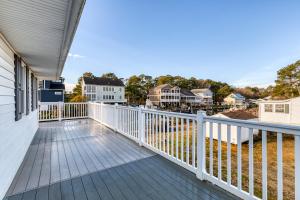 a balcony of a home with a white railing at Snug Harbor Sunrise Entire Home in Berlin