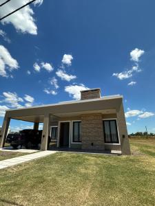 a house with a car parked in front of it at Casa quinta Laguna Brava 3 in Corrientes