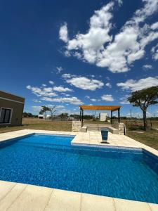 a swimming pool with a gazebo in a yard at Casa quinta Laguna Brava 3 in Corrientes