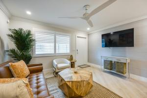 a living room with a couch and a fireplace at Naples Studio: 1 Block to Beach & Restaurants! in Naples
