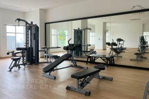 a gym with several treadmills and a large mirror at Taiping Peaceful Retreat near Lake Garden with WiFi in Taiping