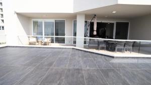 a living room with a table and chairs in a building at Jolla Excellence 3bd 2b Rosarito in Popotla