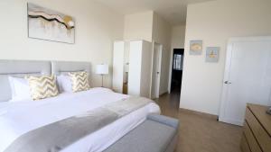 a white bedroom with a large white bed with pillows at Jolla Excellence 3bd 2b Rosarito in Popotla