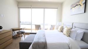 a bedroom with a large bed and a large window at Jolla Excellence 3bd 2b Rosarito in Popotla +54 photos