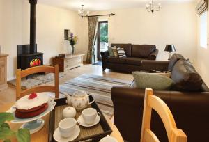 a living room with a table with a cake on it at Damson Cottage in Rainow +2 photos