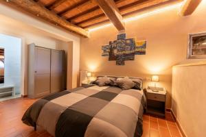 a bedroom with a bed and a cross on the wall at Serene Retreat Apt with Pool & Breathtaking Views in Volterra