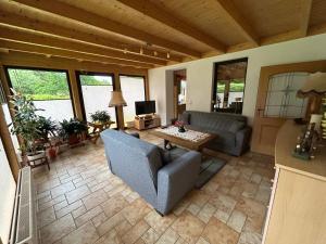 a living room with a couch and a table at Gerds Gartenwohnung in Ottrau