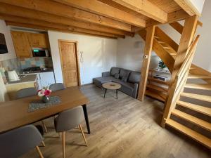 a living room with a couch and a table at AquaRelax Liptov Tatralandia in Liptovský Mikuláš