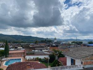a view of a town with buildings and a cloudy sky at Hotel San Vicente in Darién +10 photos
