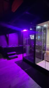 a room with purple lights in a room at Love Room Spa - Sauna - Hammam in Domérat +5 photos