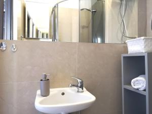 a bathroom with a sink and a mirror at STARE MiASTO II in Olsztyn +12 photos