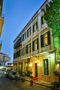 a building on a street with cars parked in front at 1905 Boutique Hotel in Xanthi