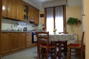 a kitchen with a table and chairs and a window at appartamento Nonna Mary in San Piero a Sieve