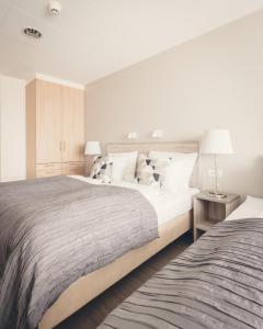 A bed or beds in a room at Hótel Fransiskus Stykkishólmi