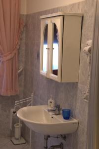 a bathroom with a sink and a mirror at appartamento Nonna Mary in San Piero a Sieve