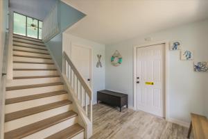 a staircase in a home with a white door at Sunshine Lagoon in Sanibel