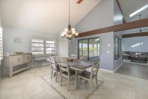 a dining room and kitchen with a table and chairs at Sunshine Lagoon in Sanibel