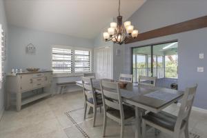 a dining room with a table and chairs at Sunshine Lagoon in Sanibel +32 photos