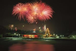 a fireworks display over a building with a christmas tree at Best Western Aparthotel Birnbachhöhe in Bad Birnbach +68 photos