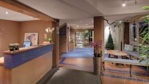 a hotel lobby with a reception desk and plants at Best Western Aparthotel Birnbachhöhe in Bad Birnbach