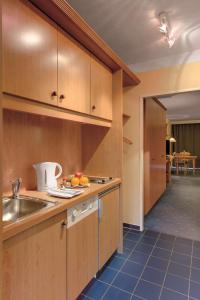 a kitchen with a sink and a counter top at Best Western Aparthotel Birnbachhöhe in Bad Birnbach +63 photos