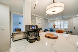 a kitchen with a counter with a coffee maker on it at Upscale Naples Condo with Pool Access Walk to Pier! in Naples