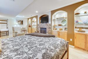 a bedroom with a bed and a fireplace at CO Springs Apartment in the Pines with Treehouse! in Gleneagle