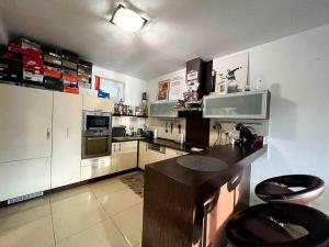 a large kitchen with stainless steel appliances and counters at Central AREA Cozy Apartment in Šamorín