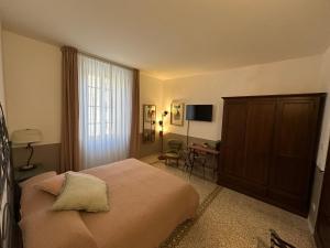 a bedroom with a large bed and a desk at L'Altro Sapore Rooms in Pitigliano +29 photos