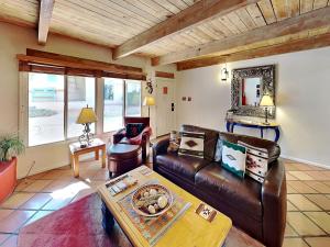 a living room with a leather couch and a table at Artist Road #7 in Santa Fe