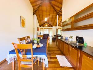 a kitchen with a table and a dining room at Deer Hill Rest Kandy in Kandy