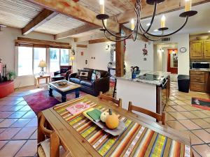 a living room with a dining table and a kitchen at Artist Road #7 in Santa Fe