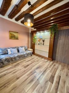 a living room with a couch and wooden floors at Emma's House in Venice