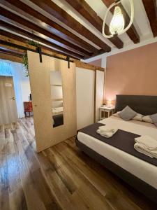a bedroom with a bed and a wooden floor at Emma's House in Venice
